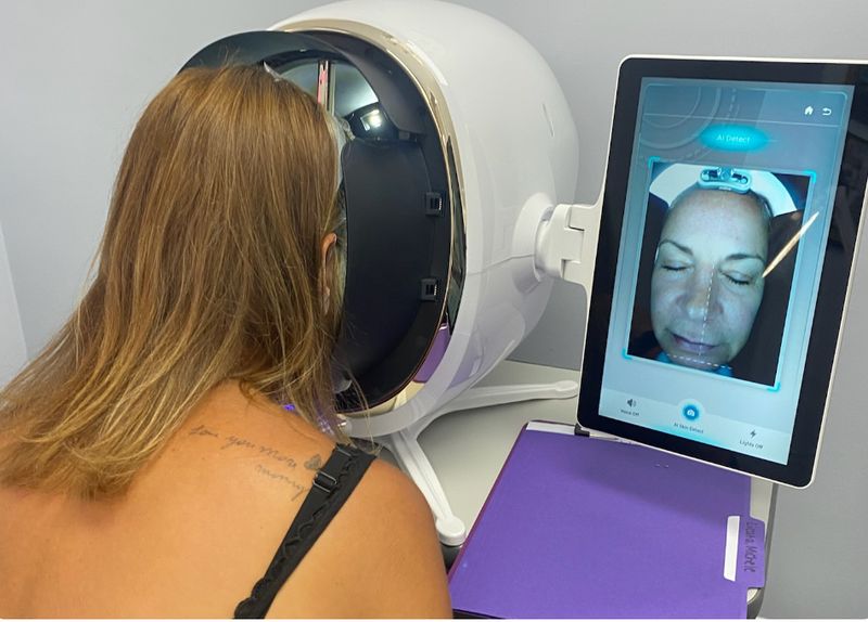A patient’s face being mapped by the AI skin analysis scanner at Hudson Aesthetics MD