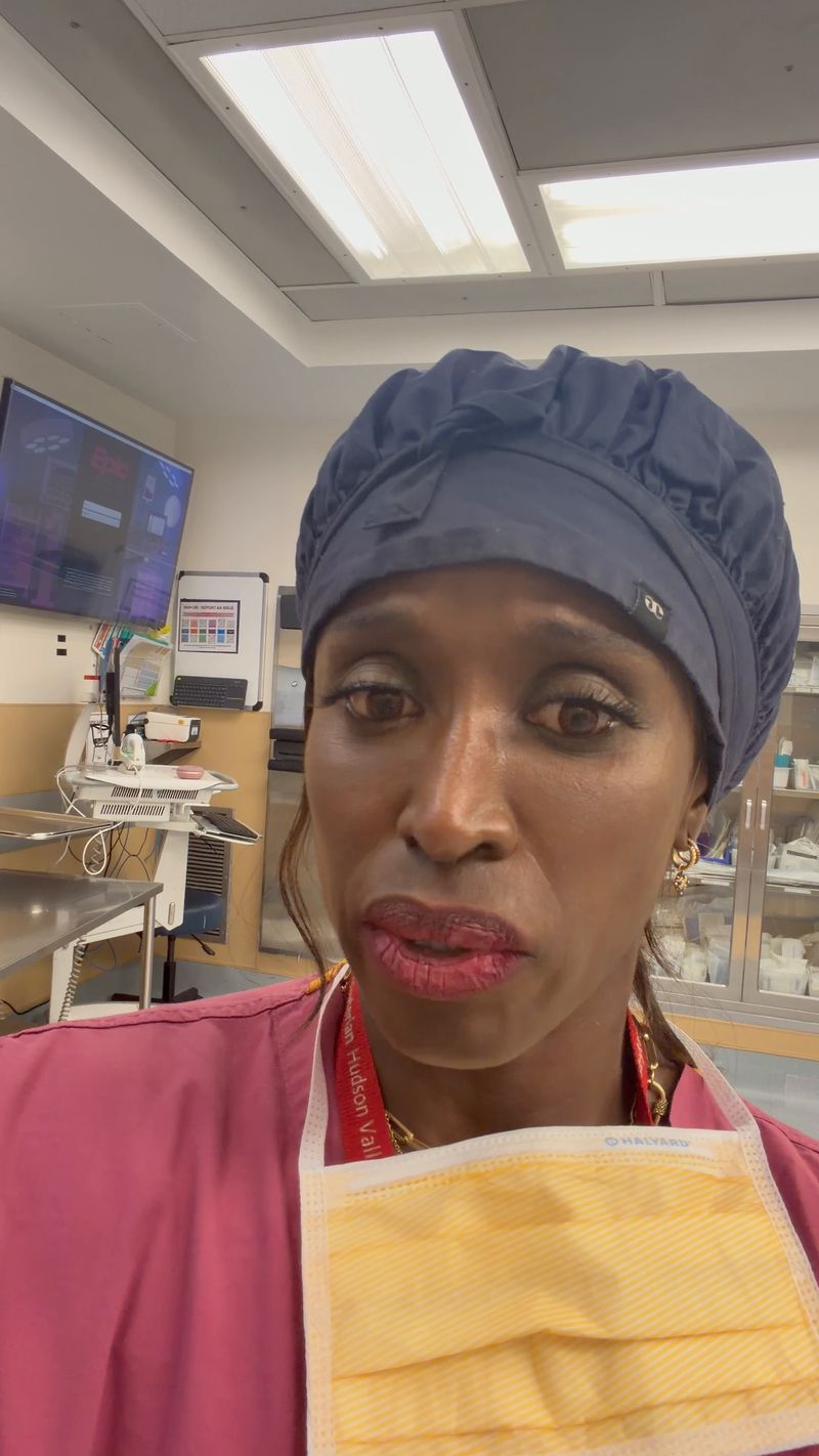 Dr. Kerline Marcelin in surgical scrubs and cap in an operating room